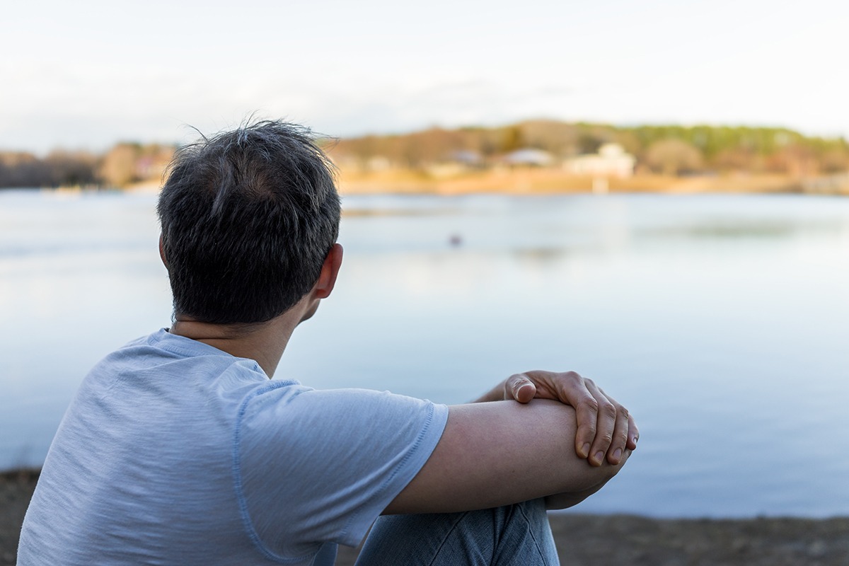 man looking out over water avoiding drug use