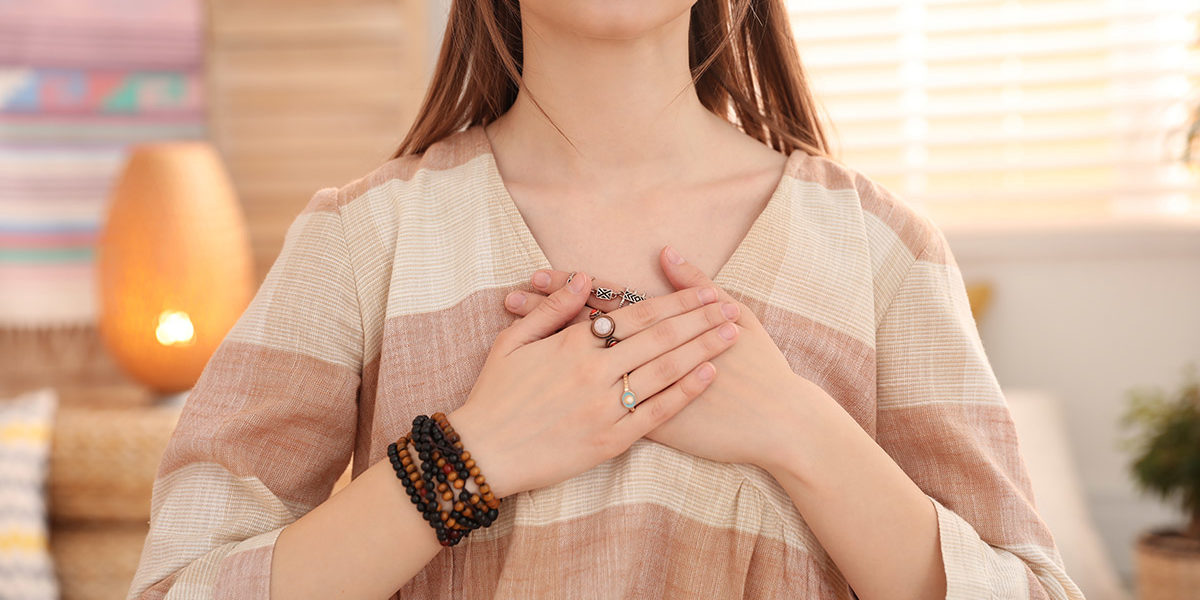 woman with hands over heart showing emotional awareness