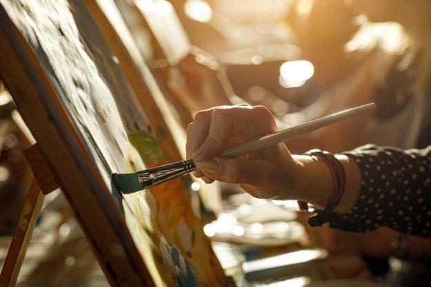 a person practices art therapy for addiction